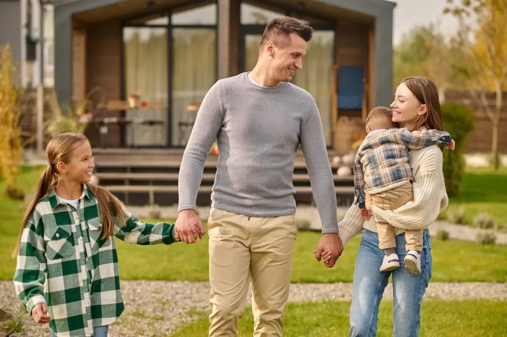 A family standing outside an inherited home, with paperwork in hand, symbolizing the beginning of the probate process.